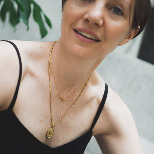 gold necklace angel protection san miguel kora garro Clio